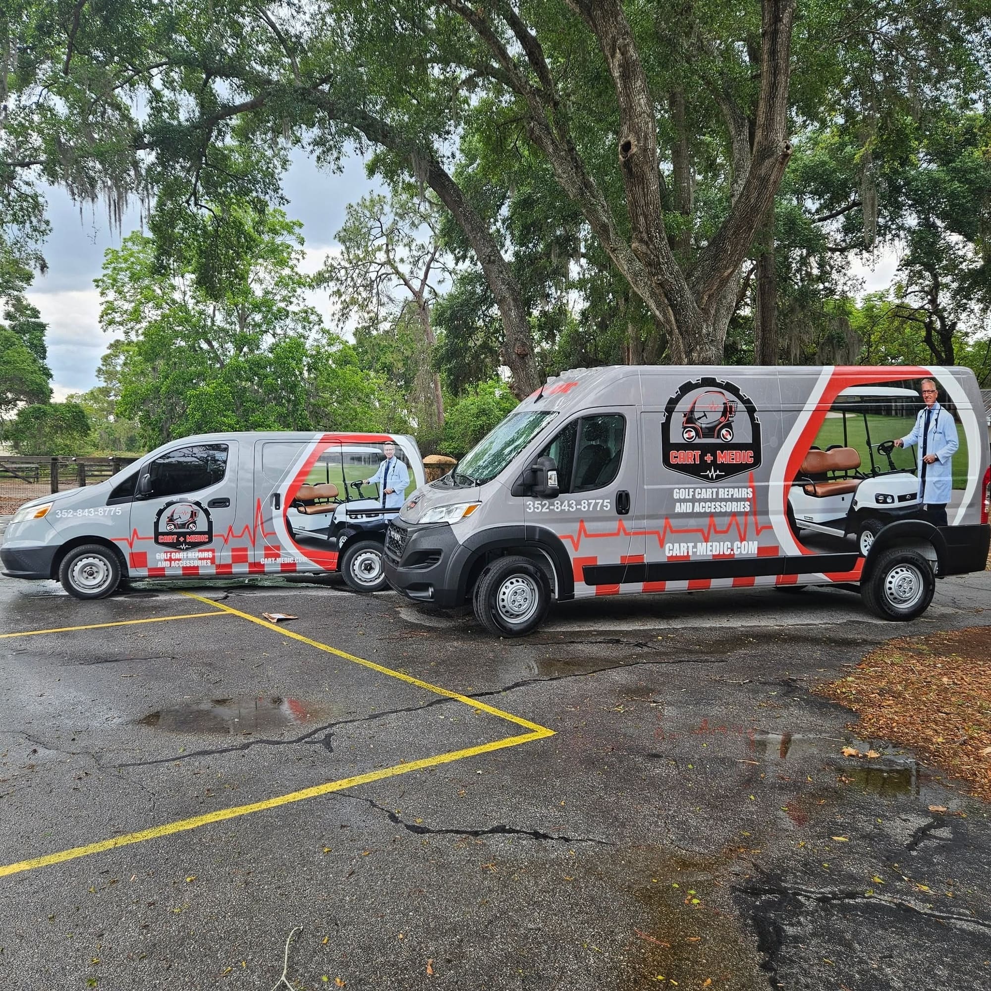 Two Cart Medic mobile golf cart service vans parked beneath oak trees